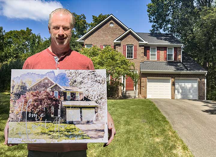 Brian C. holding a custom watercolor house portrait, gifted to his wife in Alexandria, VA.